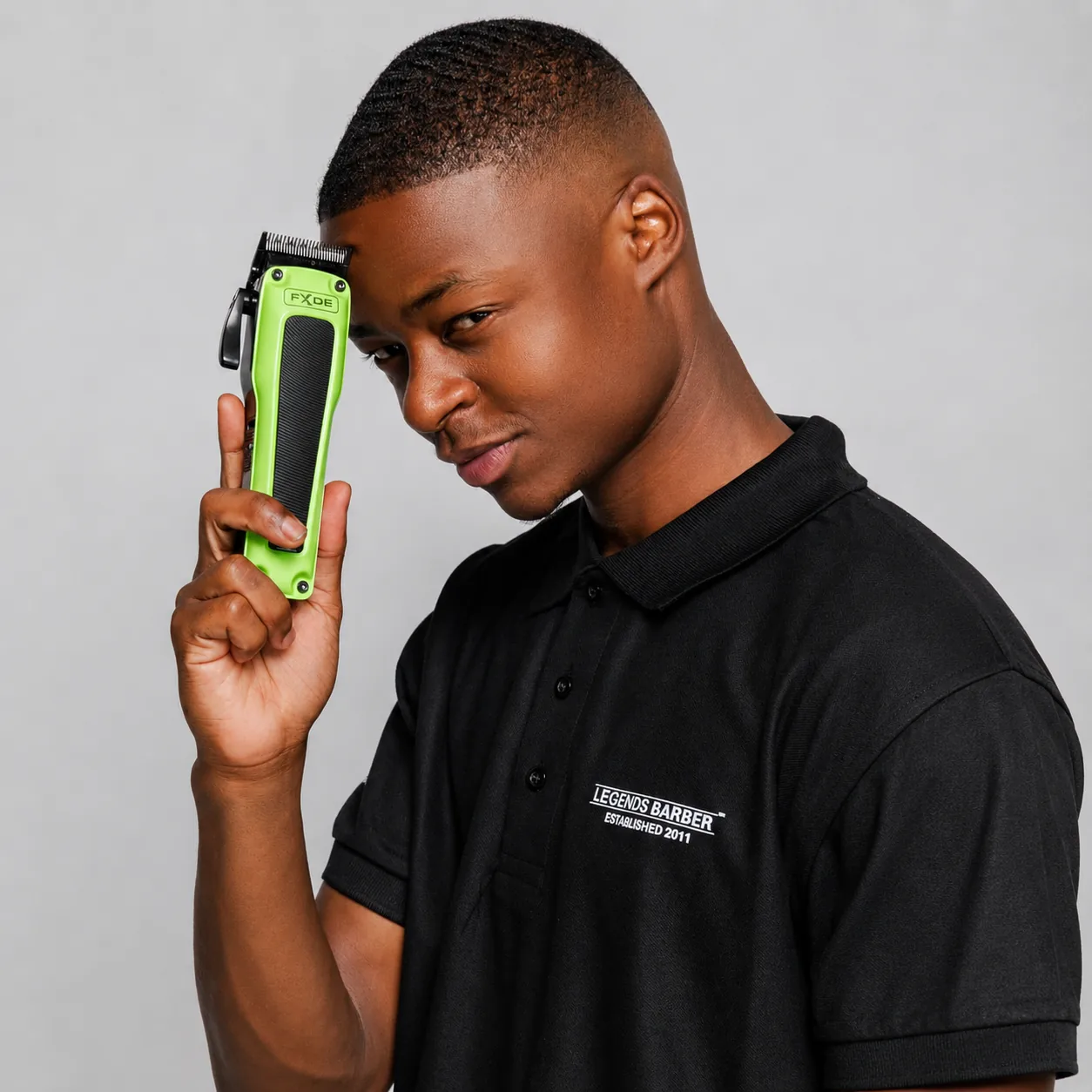 Barber holding FXDE clippers