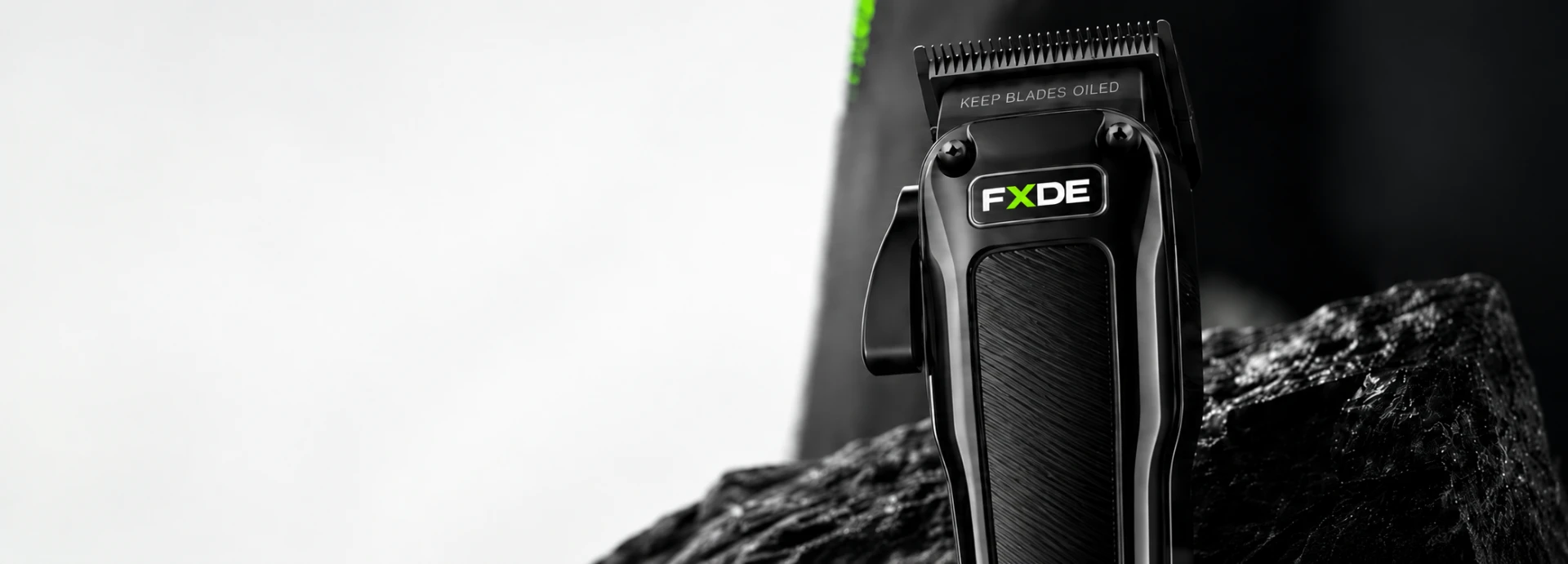 FXDE professional clipper on a black rock display